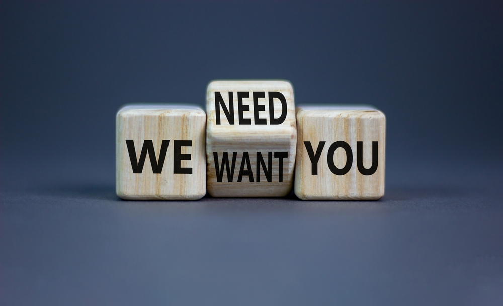 Drei Würfel mit dem Text: We want you - We need you